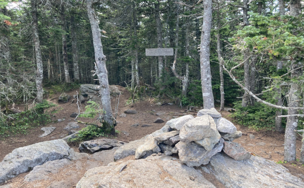 Summit cairn and sign. 