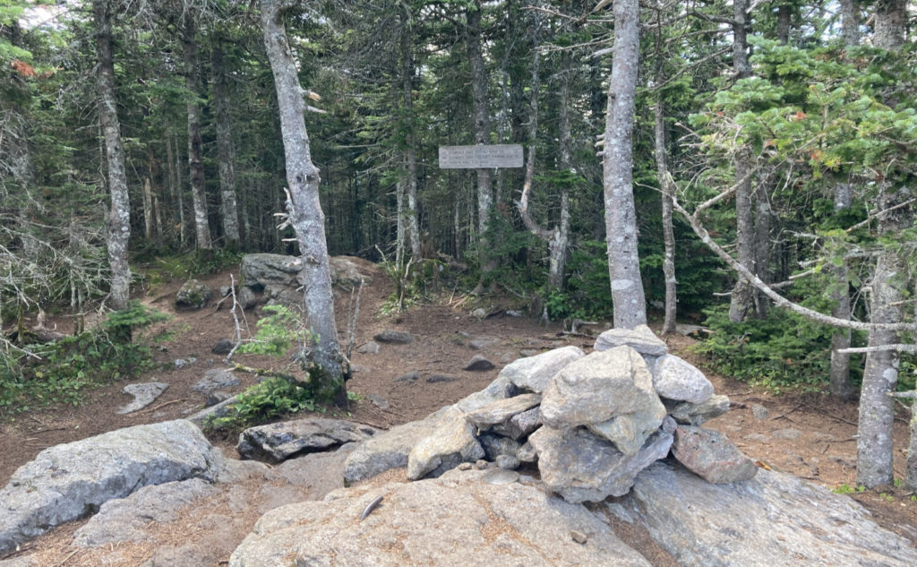 Summit cairn and sign.