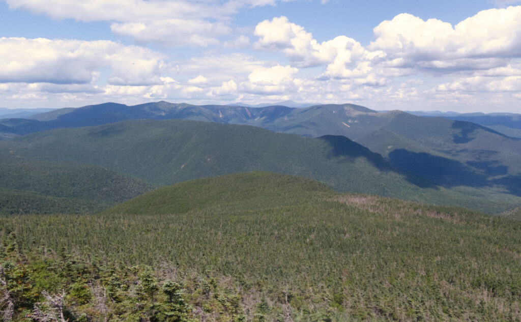 Pemi Loop 2022: A photo with several mountains: Owl's Head in the near-distance, then the Twins and the Bonds, and way beyond, Washington. 