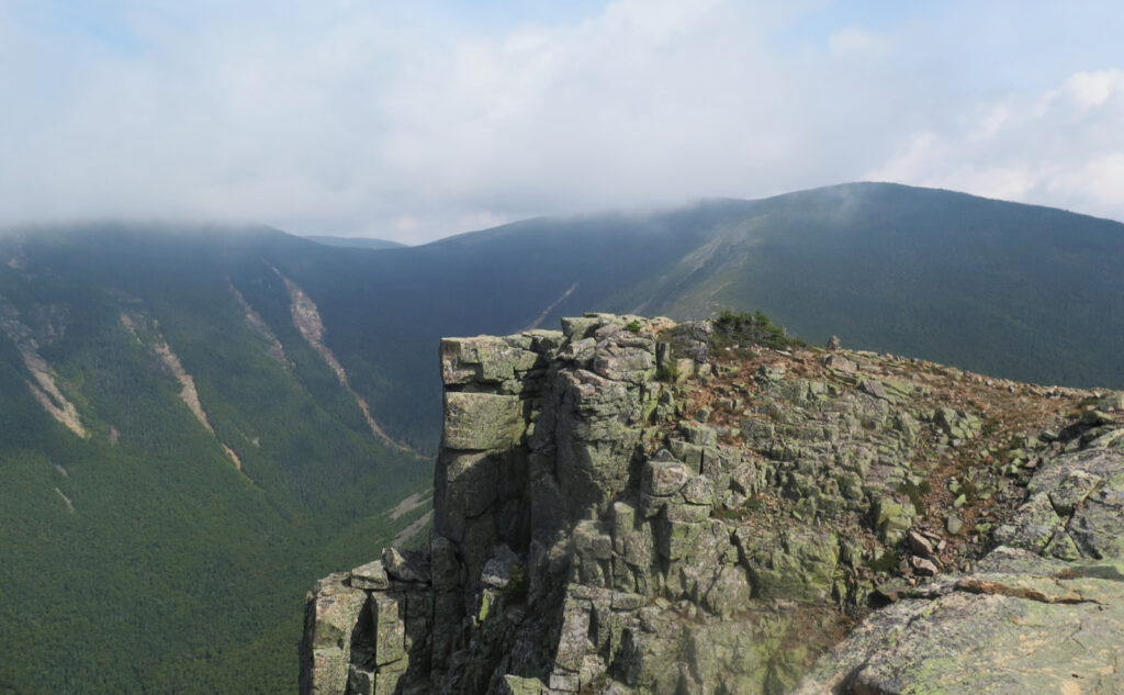 View of the picturesque ledge on Bondcliff. Mt Bond in the background obscured by clouds. 