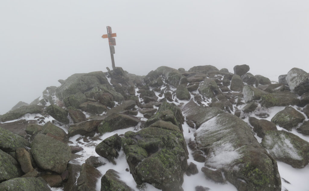 Summit sign in the fog, ice, and snow. Mt Moosilauke, Benton, NH. 2 May, 2023