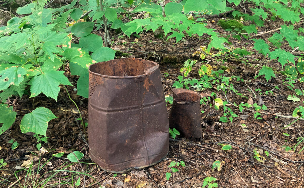 Rusty metal cans. 
Pemigewasset Wilderness, east side, White Mountains, New Hampshire. 