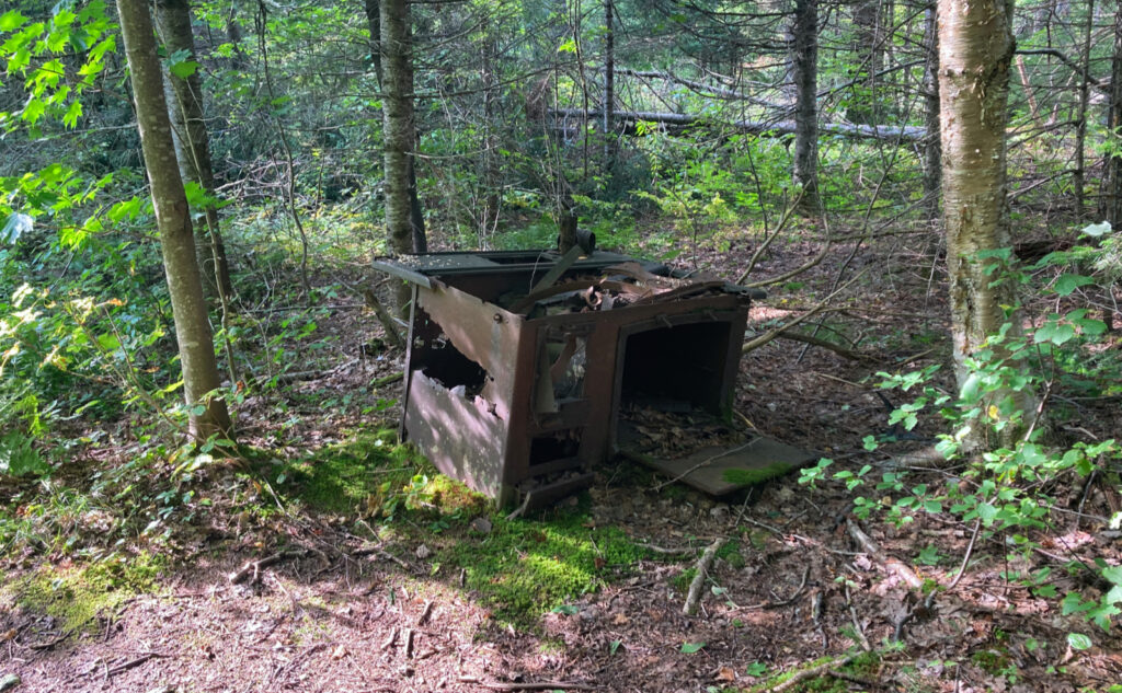 Rusted-out cast iron stove from former logging camp. Pemigewasset Wilderness, east side, White Mountains, New Hampshire. 